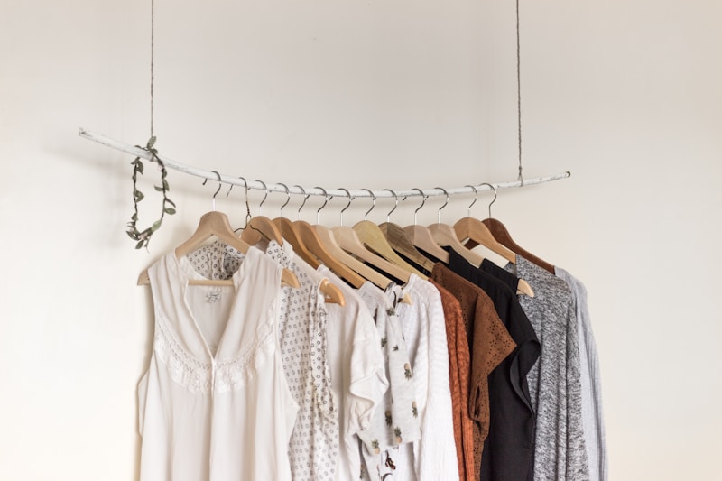 Pressed garments hanging on wooden hangers